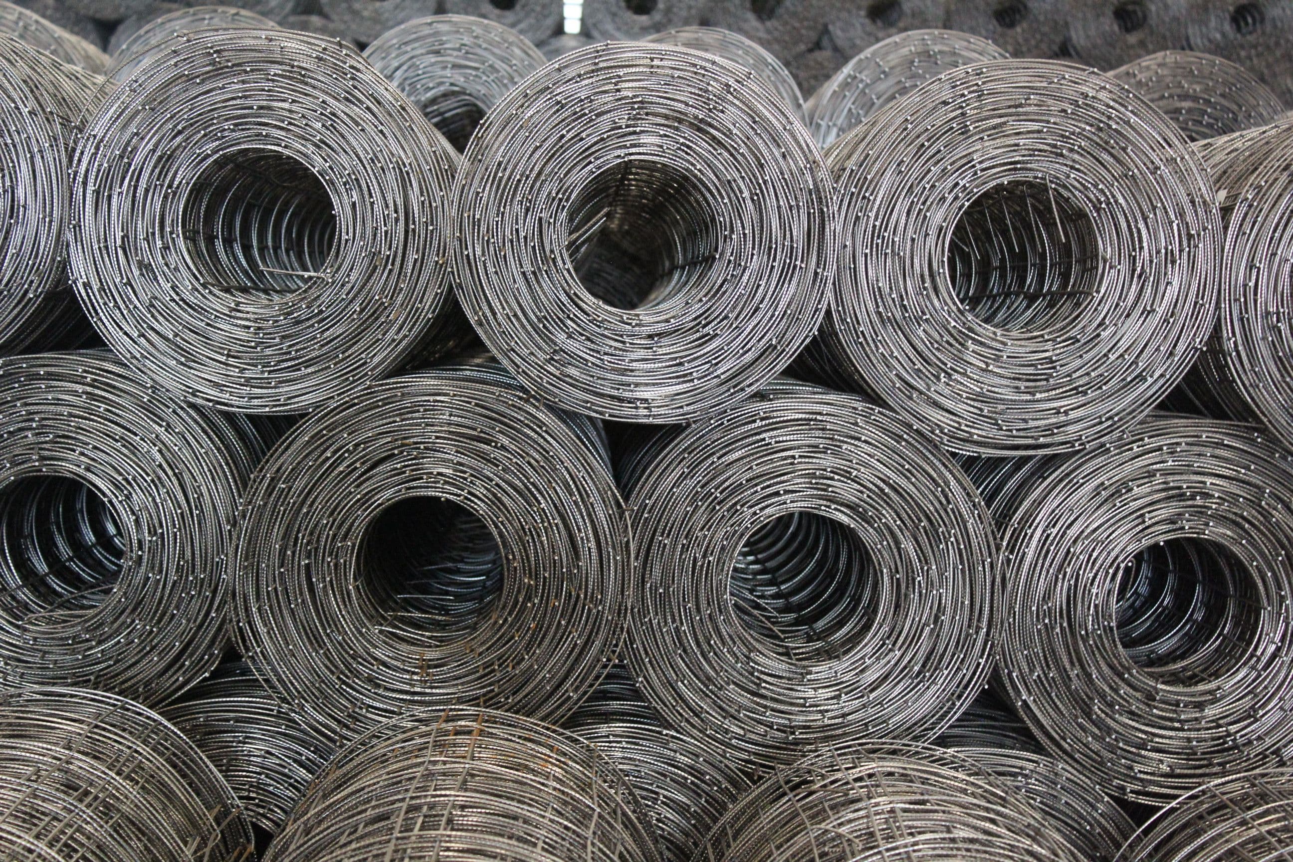 Coiled steel wire mesh rolls in a warehouse